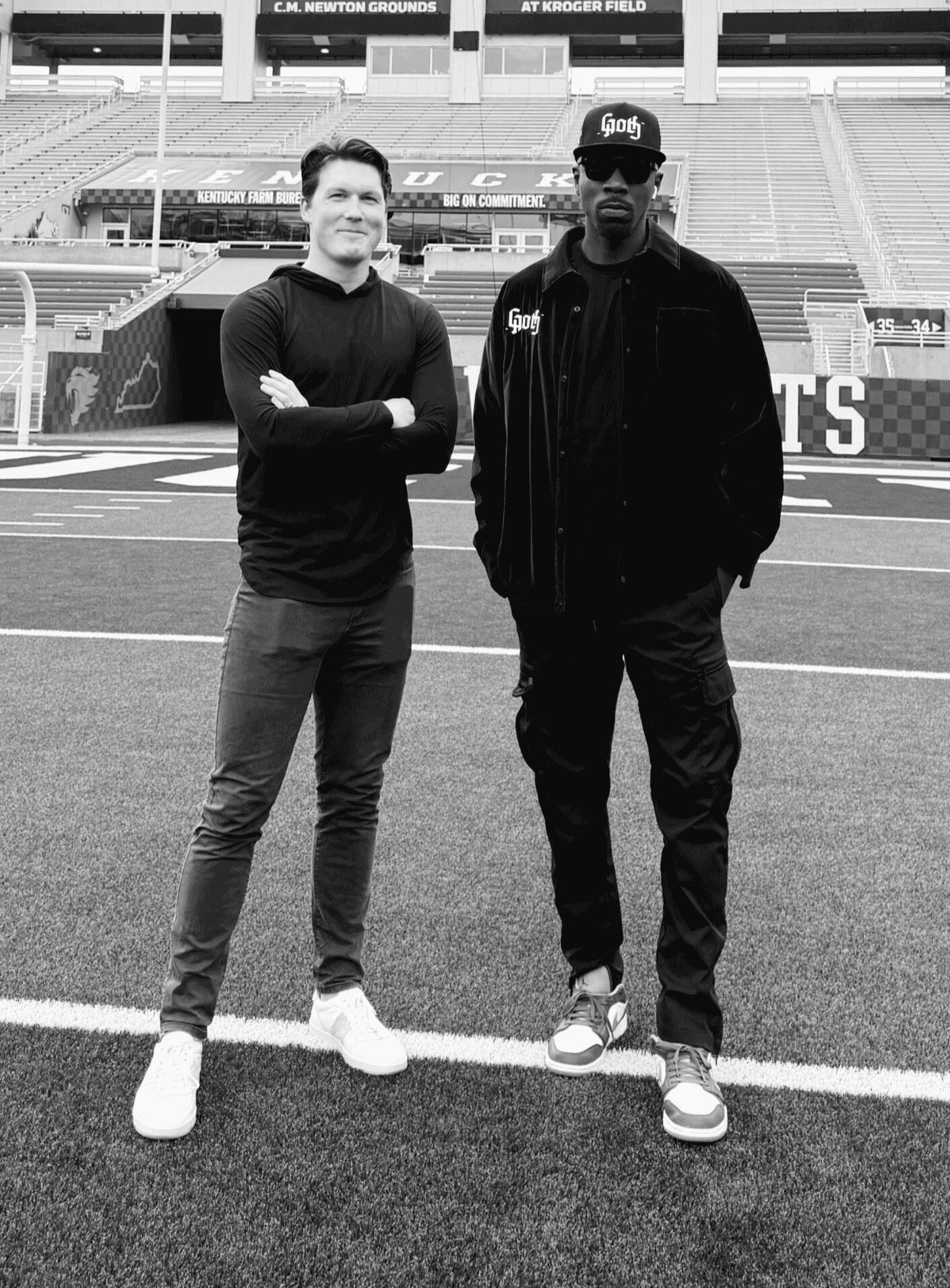 Peter Gray and Ramel Bradley standing on the field at Kroger Stadium, co-founders of More Than Academy, a nonprofit mentoring athletes through identity, leadership, and life after sport.