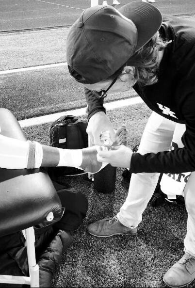 Peter Gray, Co-Founder Peter Gray, co-founder of More Than Academy, taping an athlete’s toe on the sideline.